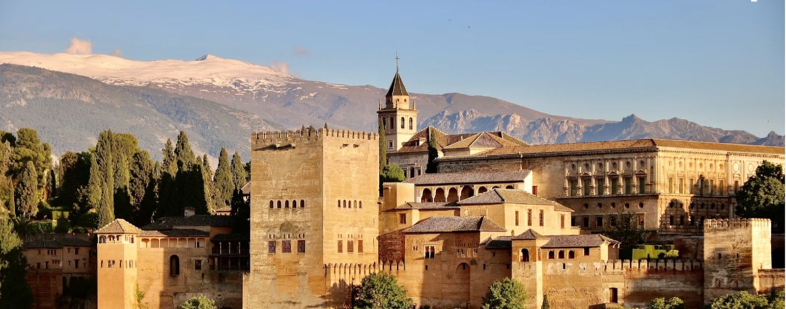 The Alhambra palace and fortress in Granada with the Sierra Nevada behind it