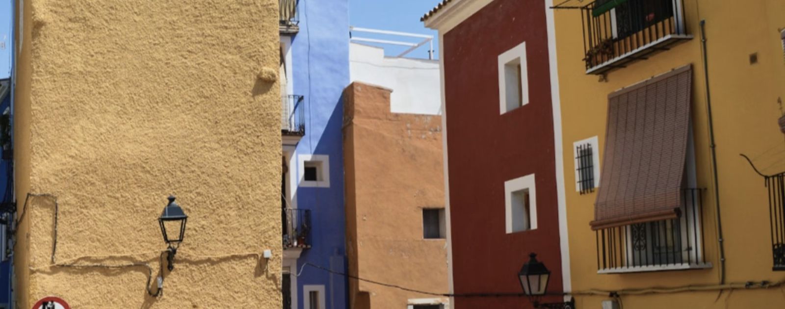 Colorful mustard, red, and orange building facades in La Vila Joiosa